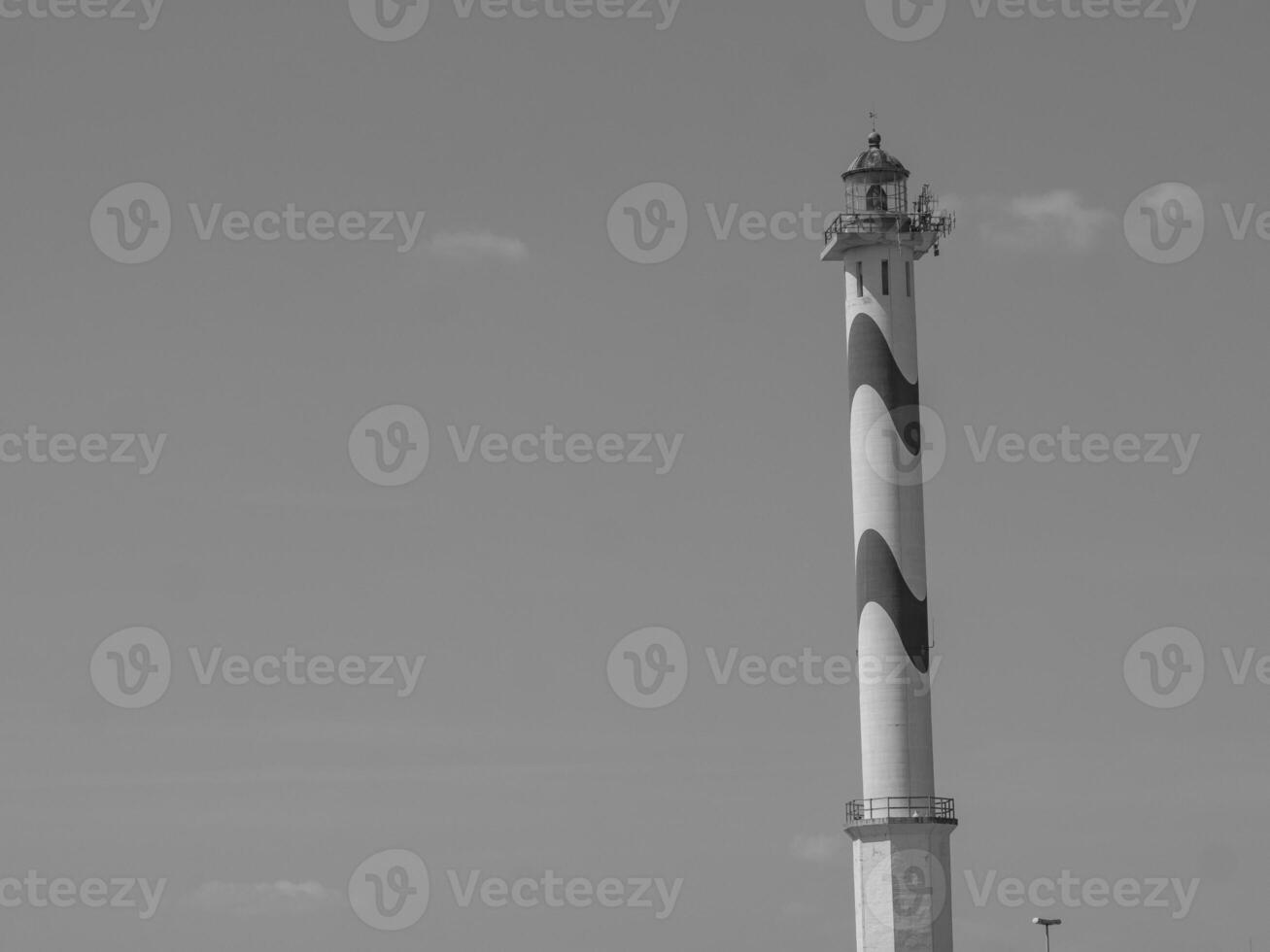 A black and white photo of a lighthouse in belgium