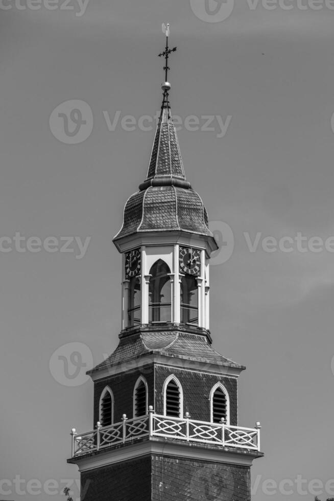 A black and white photo of a clock tower in ootmarsum