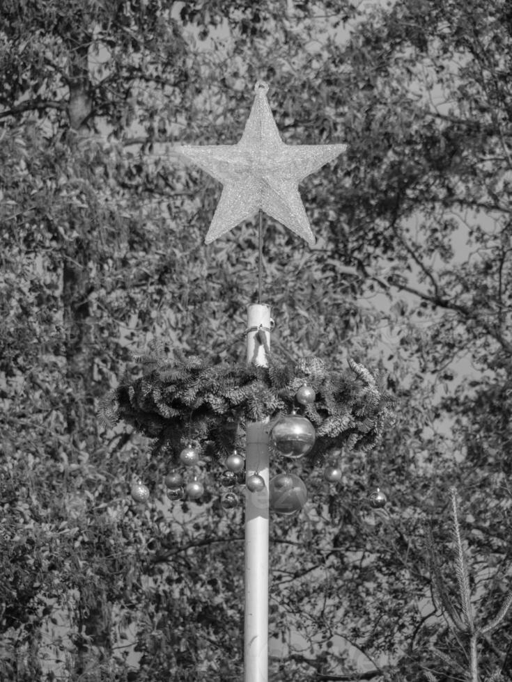 A black and white photo of a star on top of a pole