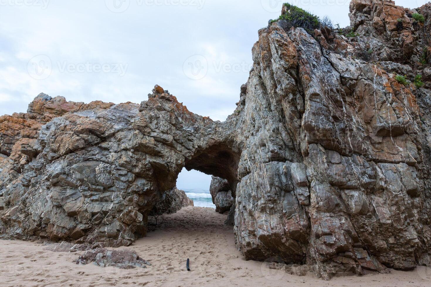 Rock Tunnel on the beach photo