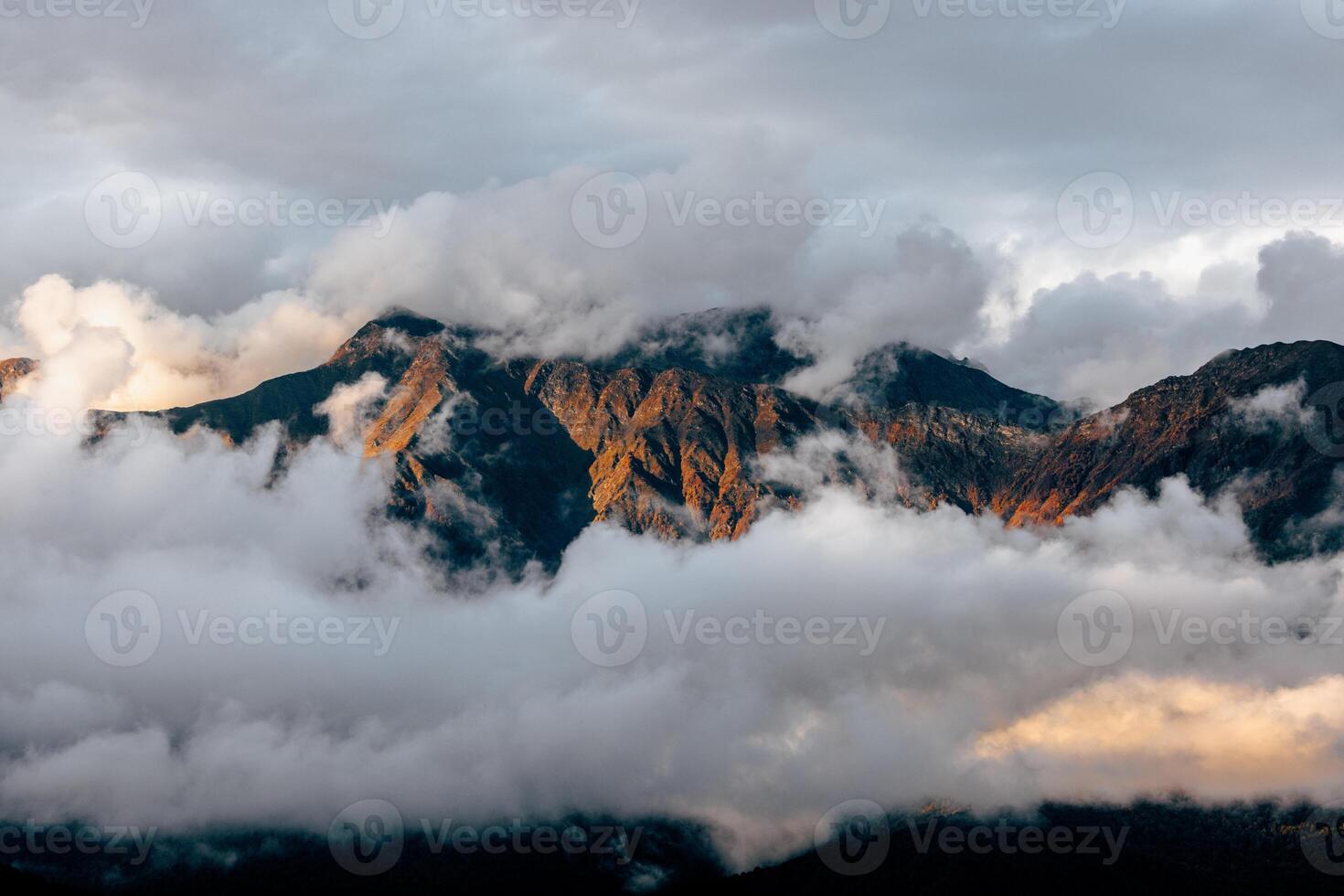 Whispers of Nature Majestic Mountains Embrace the Floating Clouds photo