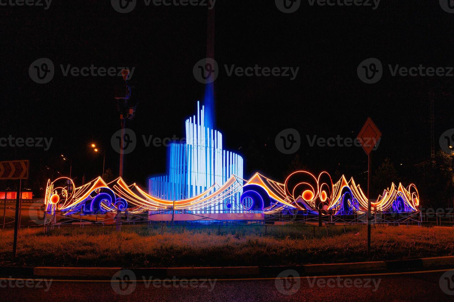 Vibrant Waters Dance A Nighttime Symphony of Light and Color Unfolds in a Captivating Fountain Spectacle. The luminous display transforms the evening, creating a magical atmosphere. photo
