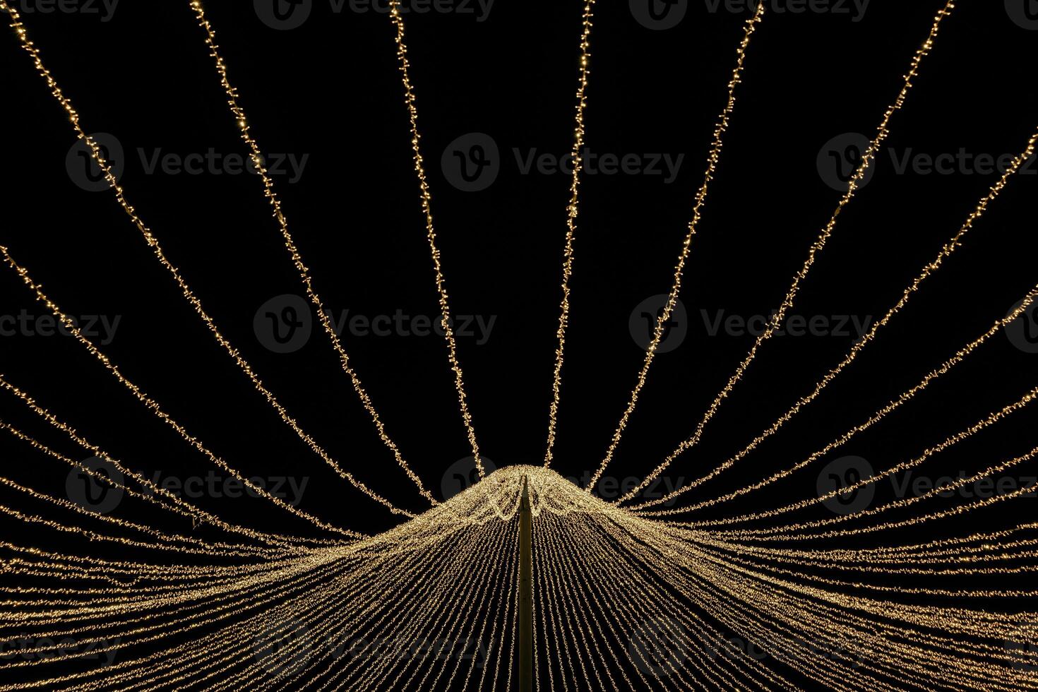 Radiant Orbs A Dance of String Lights in the Night - Delicate strands of warm light weave together in a mesmerizing radial pattern, illuminating the dark with enchanting luminosity. photo