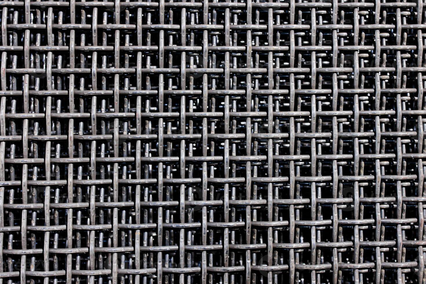 Intricate Patterns A Close-Up Exploration of Woven Metallic Textures and Light Play photo