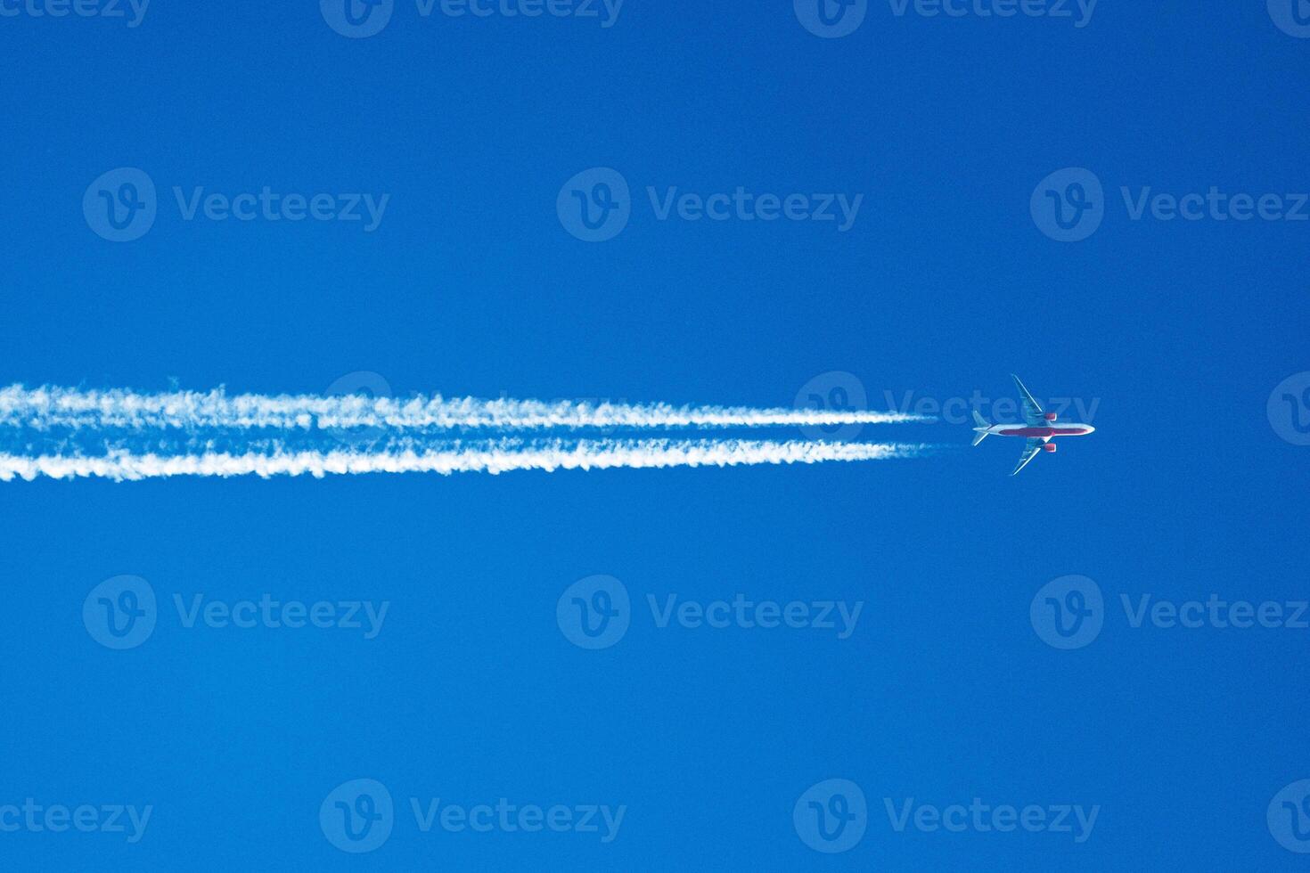 Skyward Journey A Lone Airplane Traces the Canvas of Clouds with Ethereal Contrails, Painting Dreams Across the Vast Blue Horizon. photo