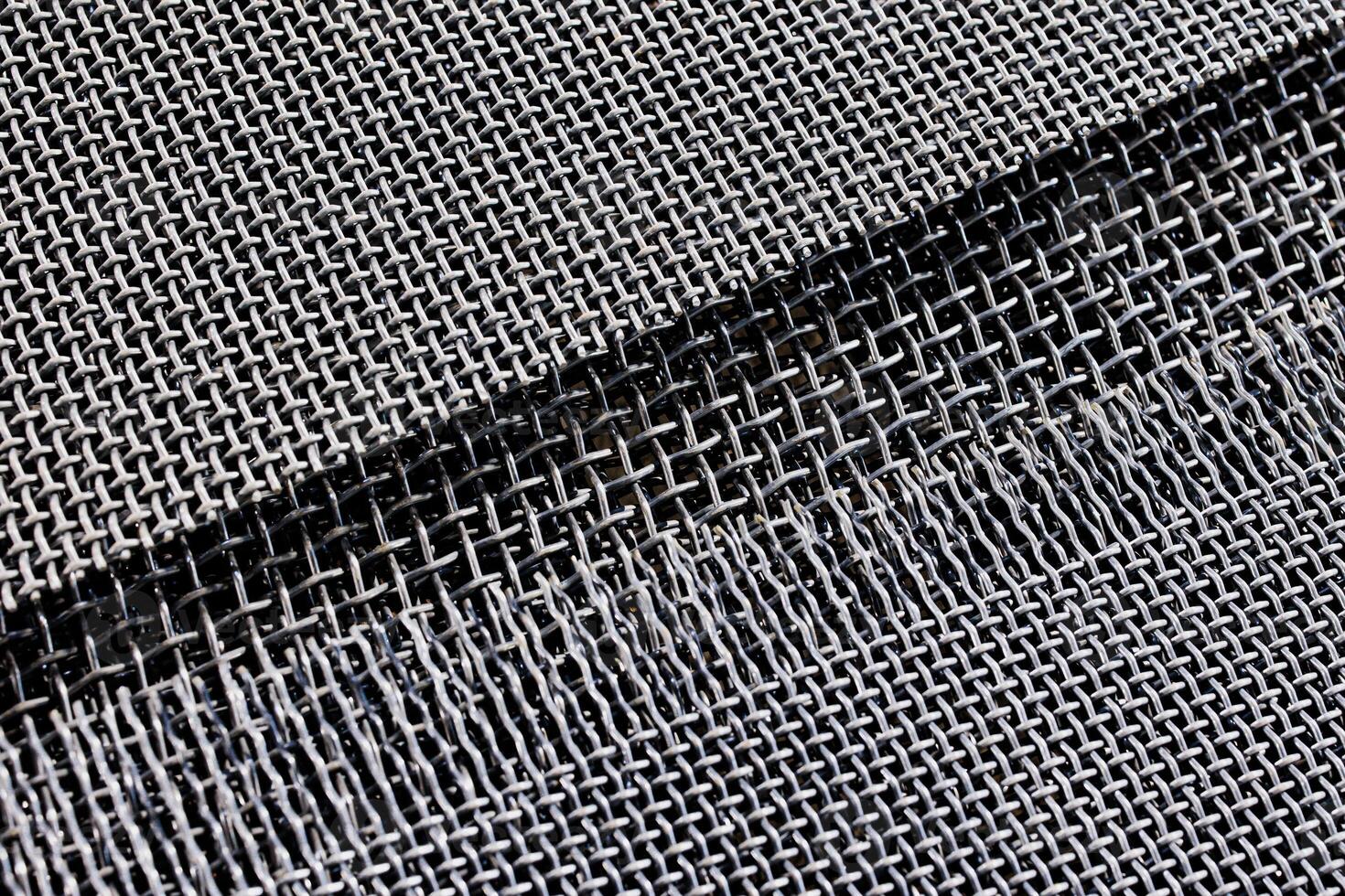 Intricate weaves of shining metal form a mesmerizing tapestry, where light dances through the delicate patterns, creating a play of shadows and reflections. photo