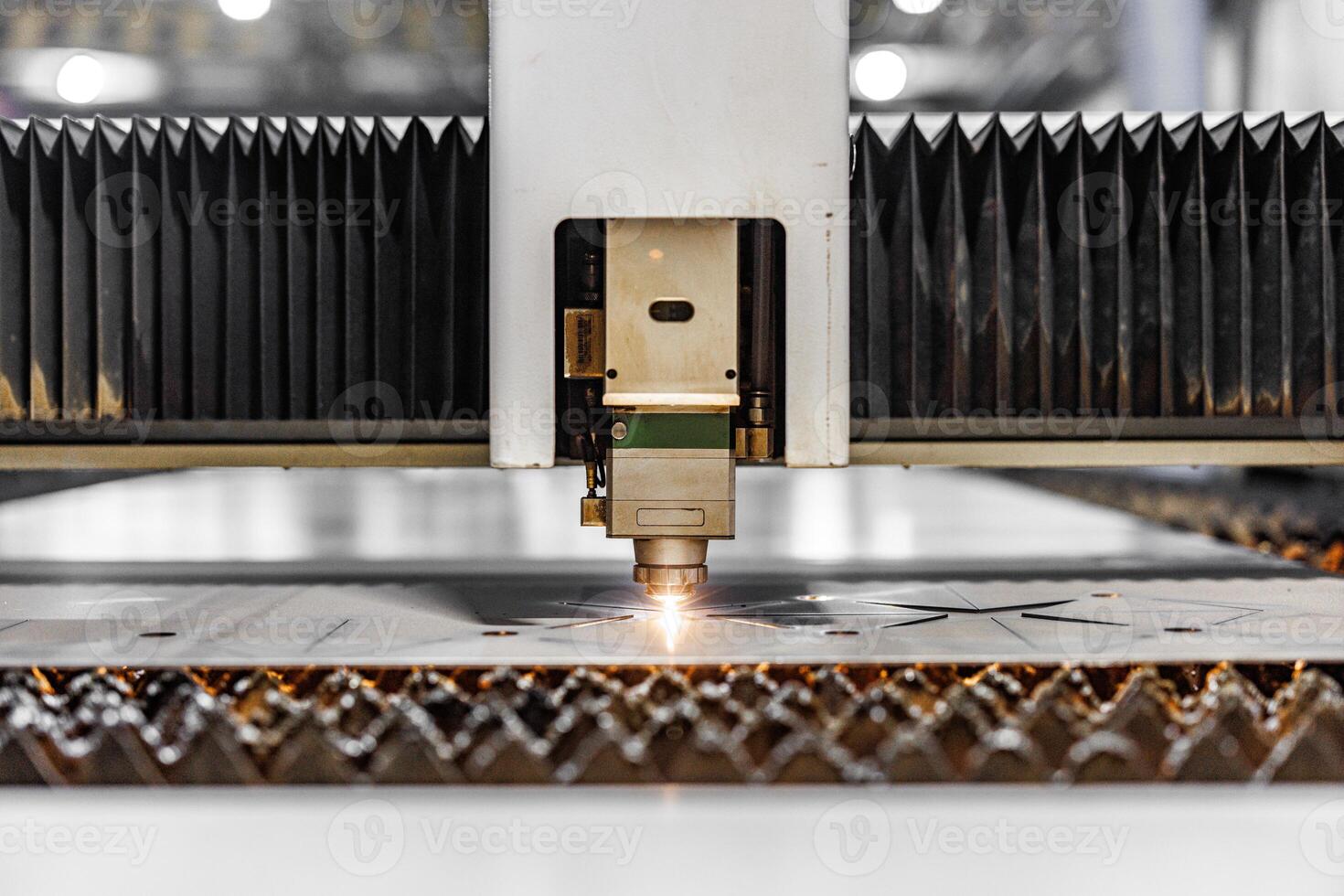 Precision in Motion A laser cutting machine carves intricate designs, transforming raw materials into stunning creations with beams of focused light. photo