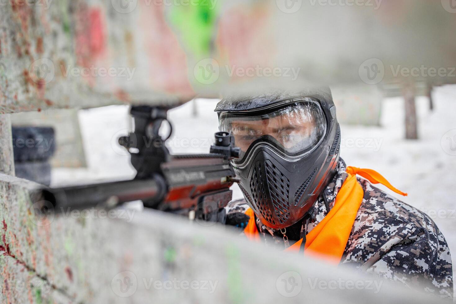 Vibrant Chaos of Paintball A Masked Warrior Engaged in a Tactical Combat Adventure photo