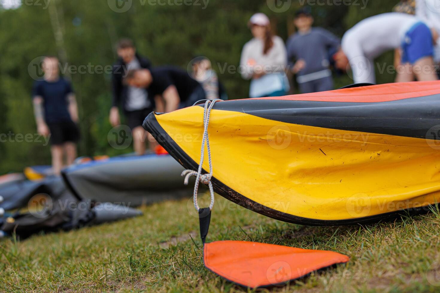 Serenity on the Shore Enthusiasts Tangle with Kayaks and Canoes Amidst Natures Embrace photo