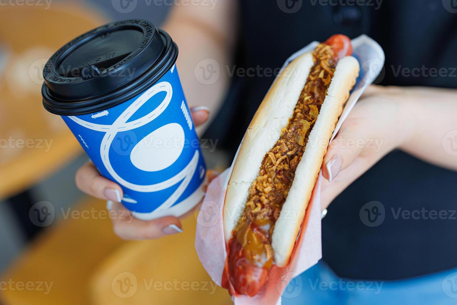Steaming Delight A Handful of Flavor and Comfort - A Perfectly Gripped Hot Dog Paired with a Warm Cup of Coffee. photo