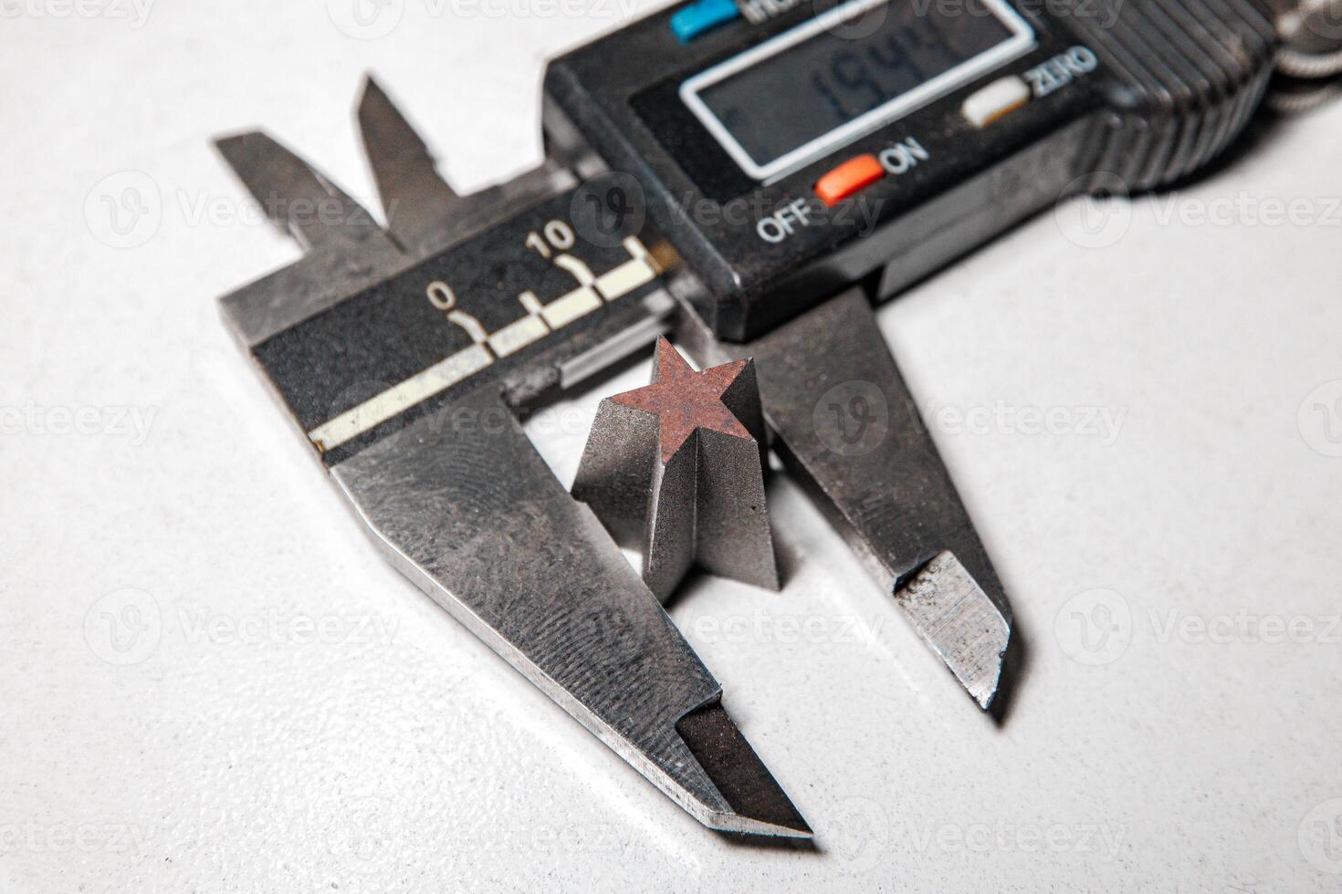 Precision in Form A Caliper Captures the Intricacies of a Star-Shaped Metal Design photo