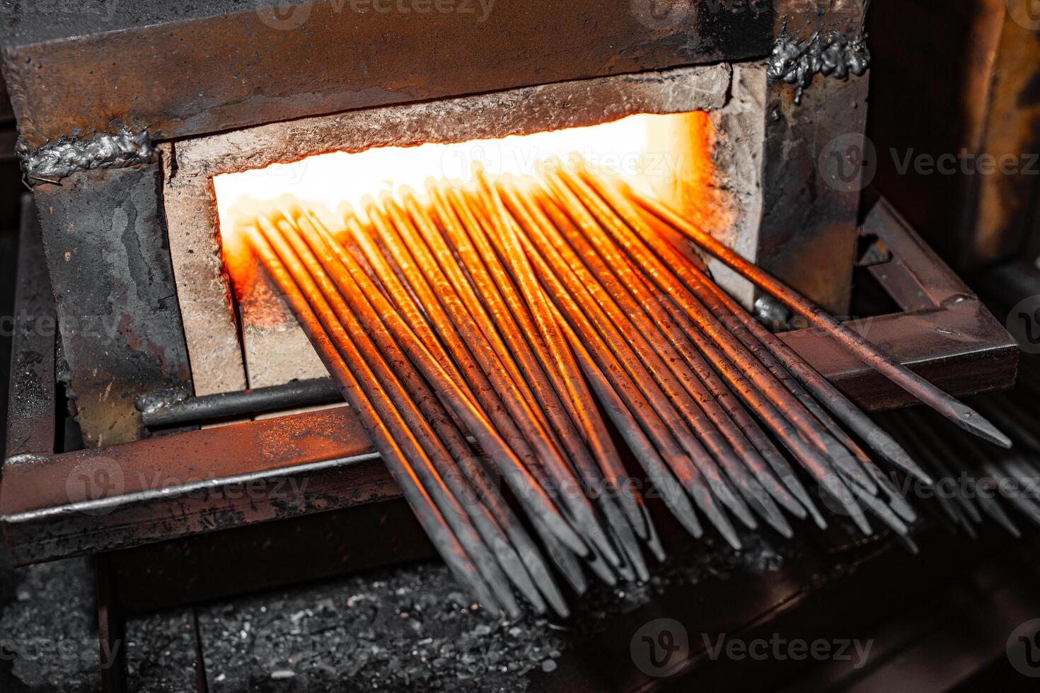 Forging Transformation Intense Heat Ignites Metal Rods in the Heart of the Furnace, Unleashing a Dance of Fire and Strength. photo