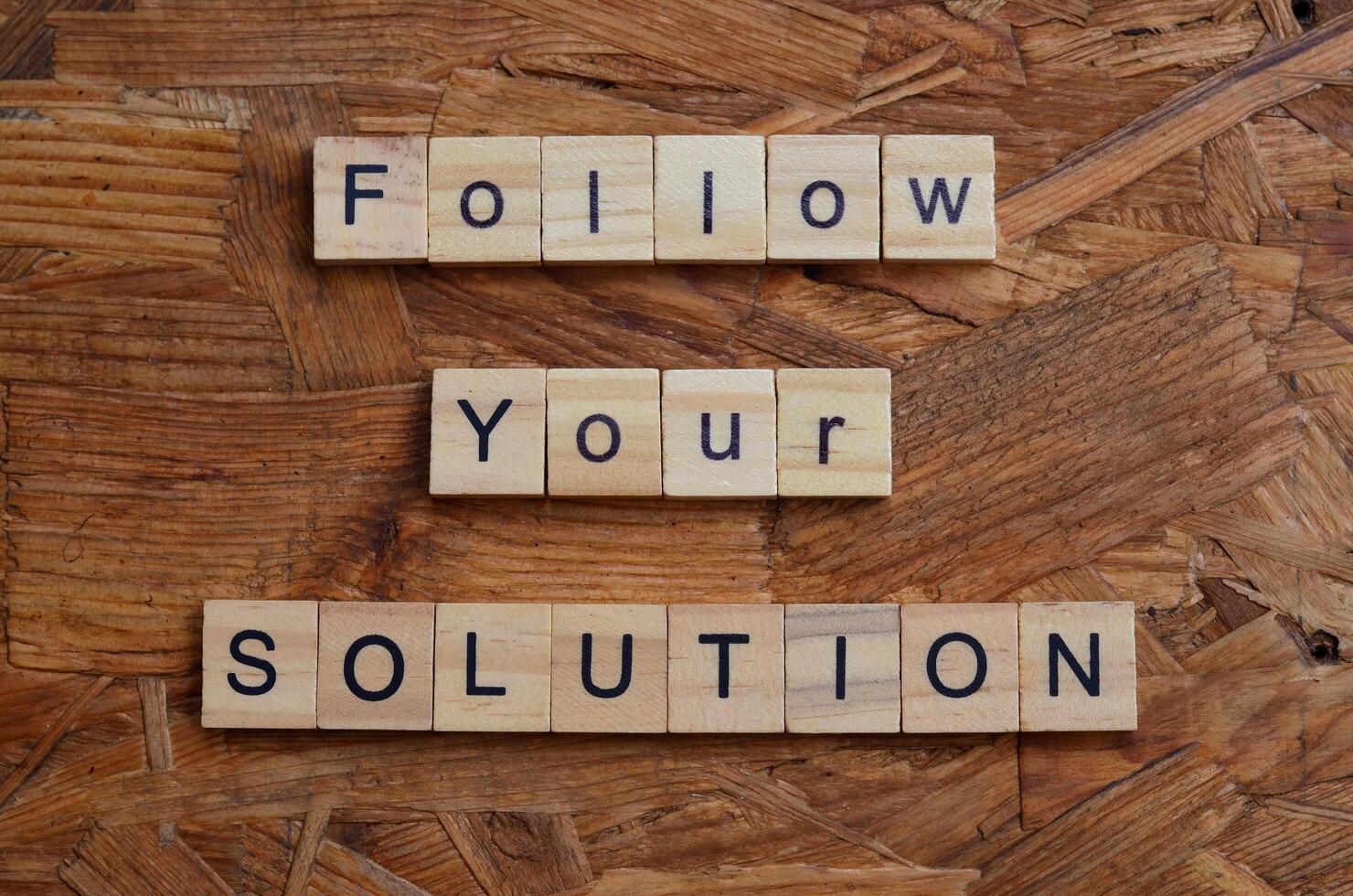 follow your solution text on wooden square photo