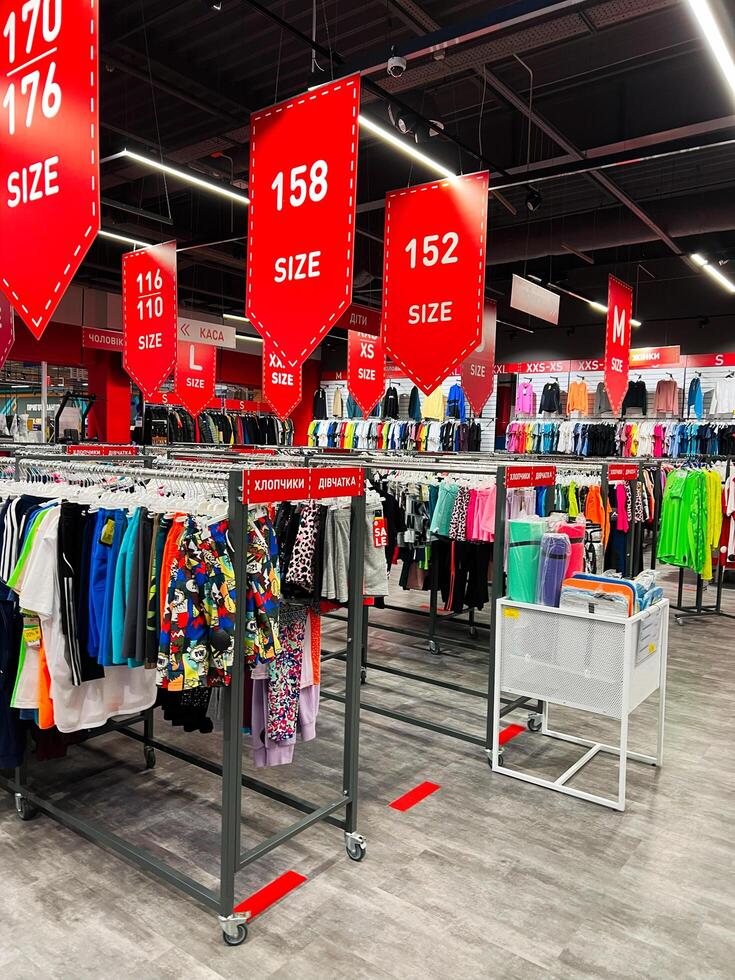 Kyiv, Ukraine - November 20, 2024 Colorful clothing store interior with size signs and displays photo