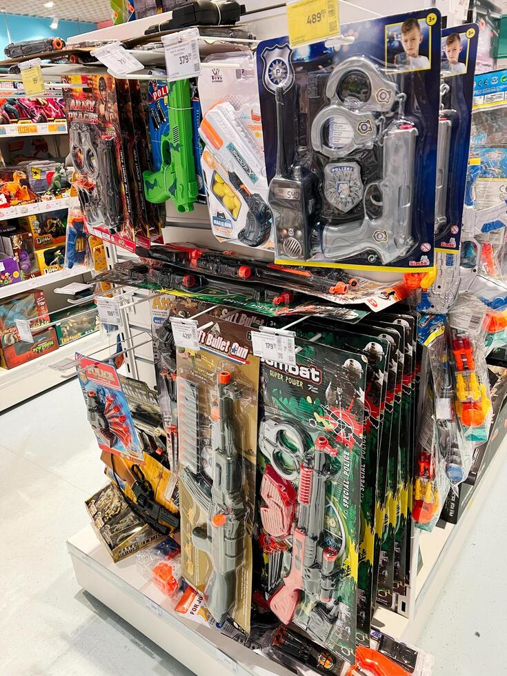 Kyiv, Ukraine - November 20, 2024 Variety of toy guns and accessories displayed in a store aisle photo