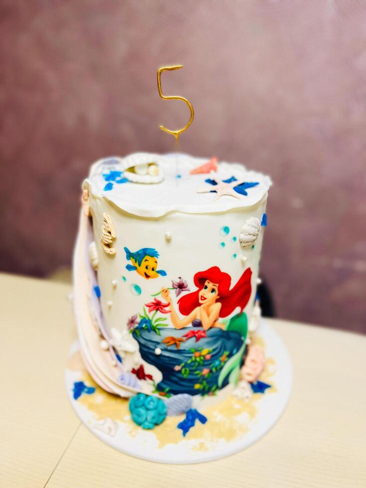 Kyiv, Ukraine - November 22, 2024 Colorful Ariel mermaid themed birthday cake with ocean decorations photo