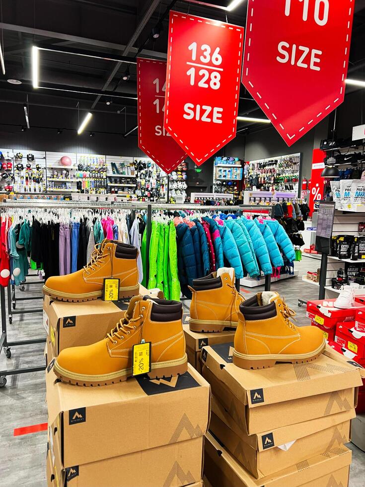 Kyiv, Ukraine - November 20, 2024 Fashionable footwear display in a vibrant clothing retail store photo