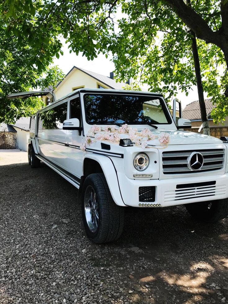 Kyiv, Ukraine - April 04, 2021 White luxury Mercedes Benz G class limousine parked in a tranquil suburban area photo