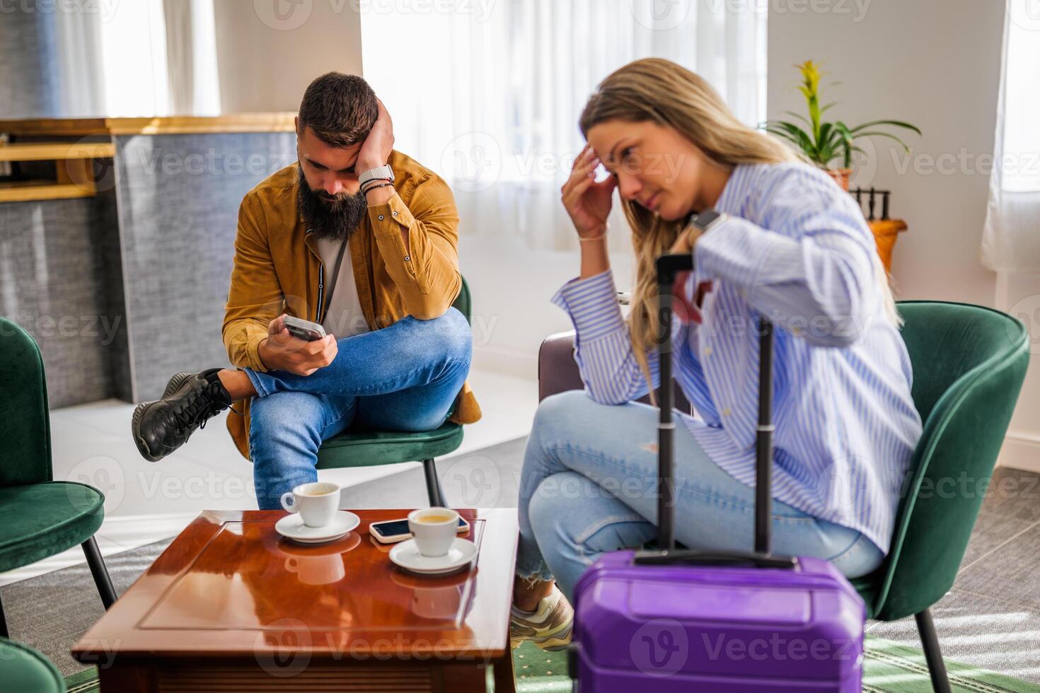 Young couple is going on vacation. Tourists sitting at airport cafe because of delayed flight. photo