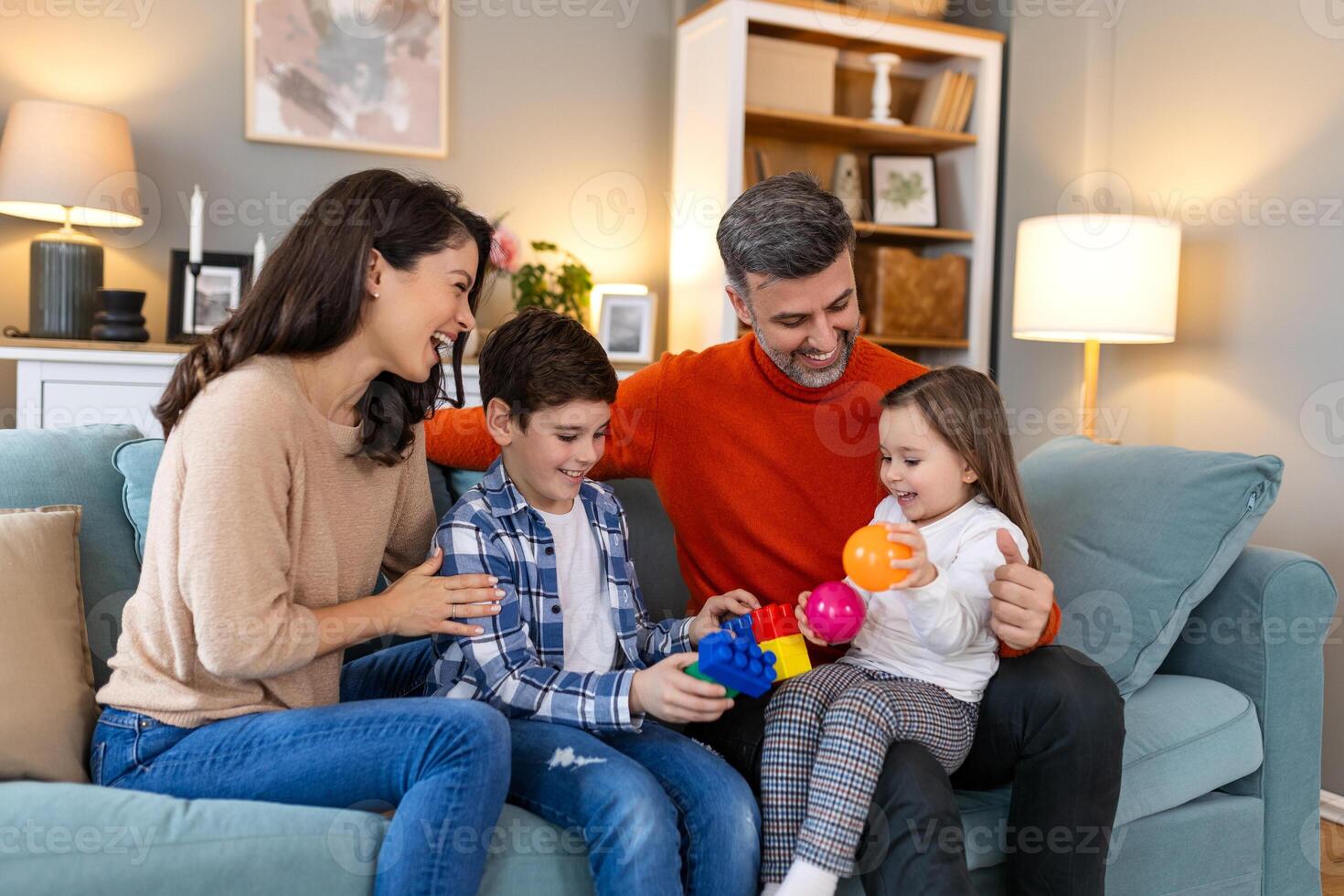A family sitting on a couch playing with toys photo
