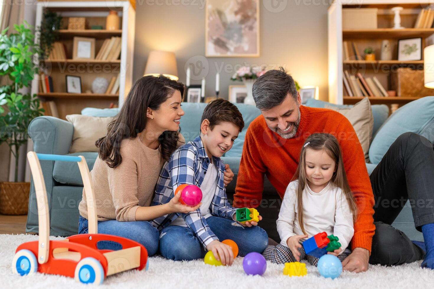 A family playing with toys on the floor photo