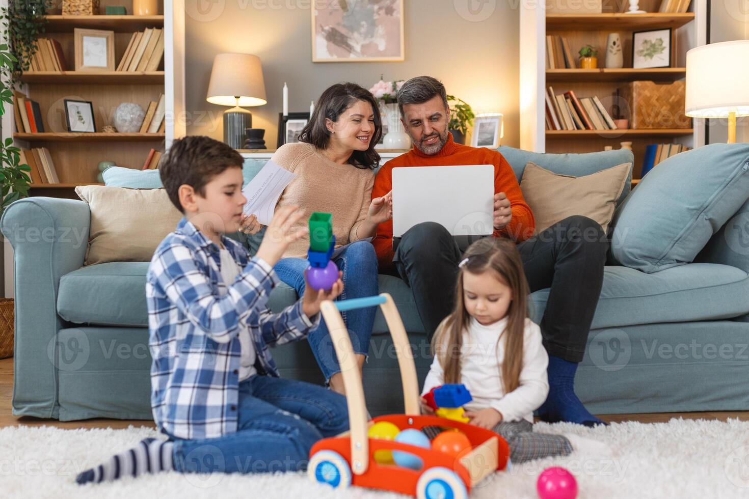 A family sitting on the floor playing with toys photo