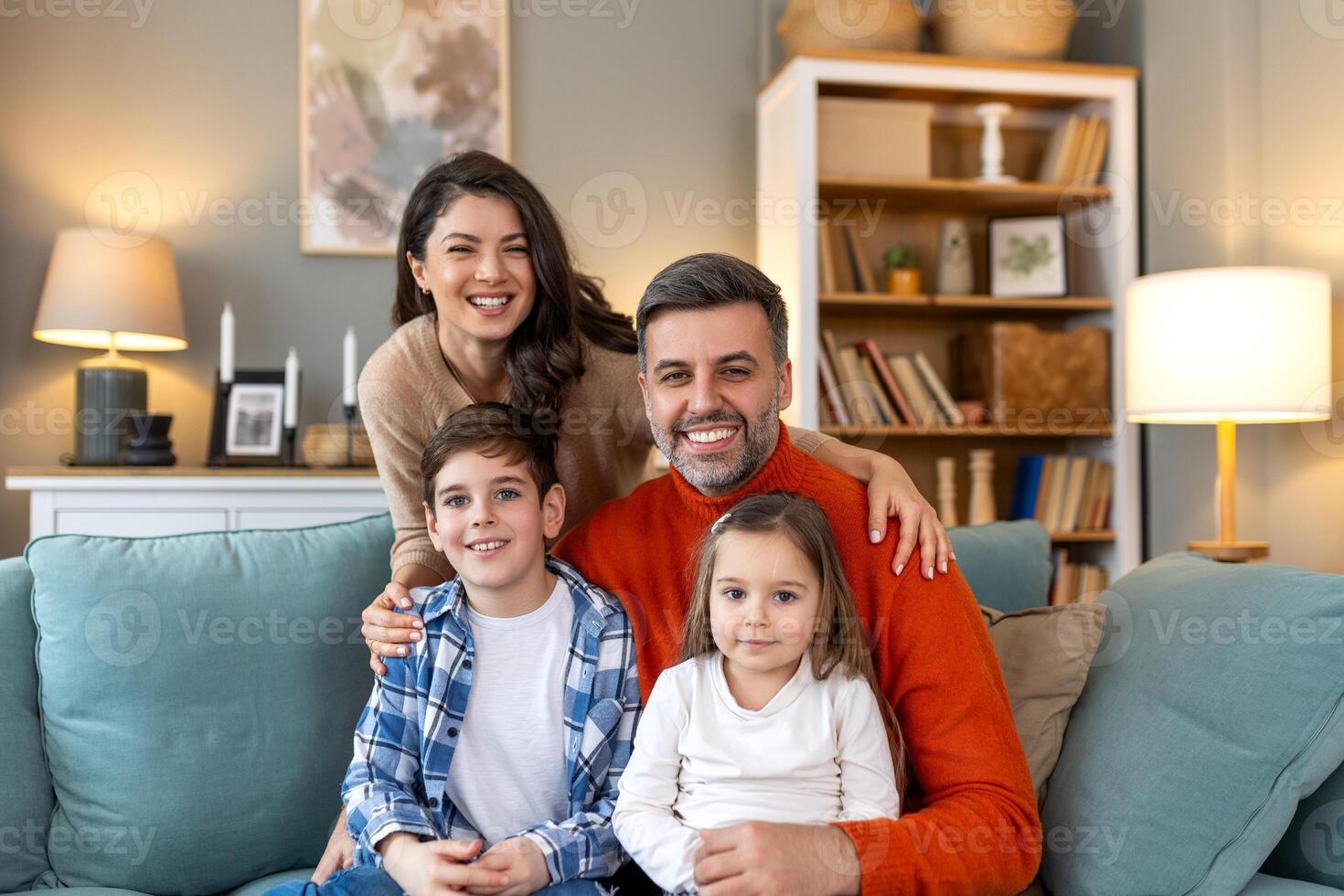 A family sitting on a couch in a living room photo