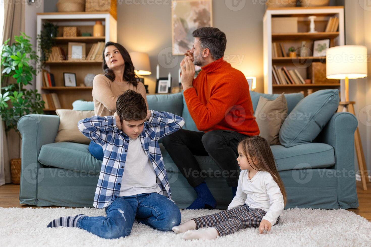 Divorce And Domestic Violence. Portrait of upset son and daughter while their angry parents fighting in the background, depressed children feeling lonely photo