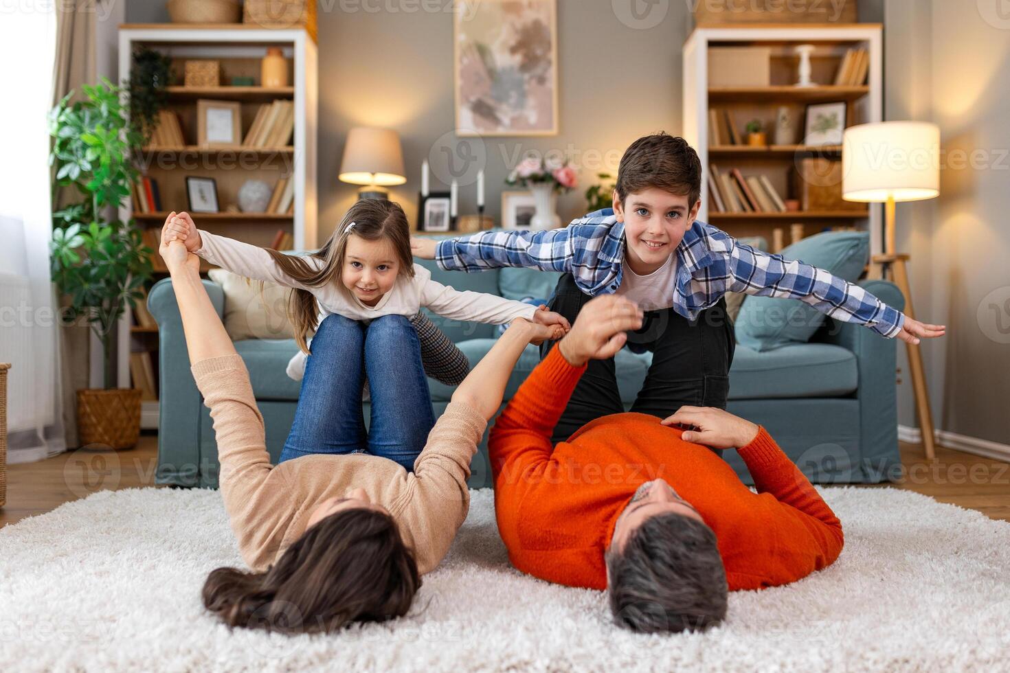 A family is playing on a rug in the living room photo