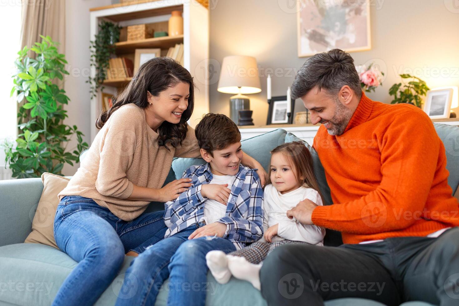 A family sitting on a couch together photo