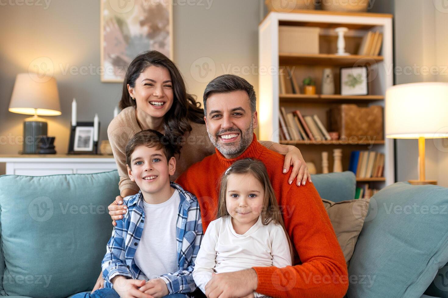 A family sitting on a couch in a living room photo