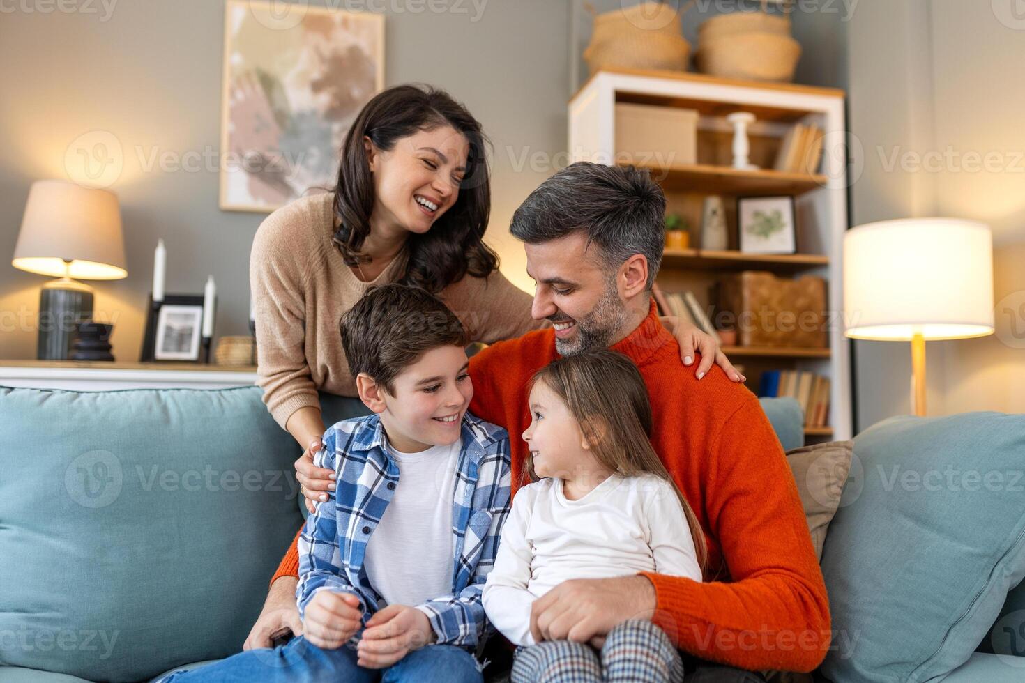 A family sitting on a couch in a living room photo