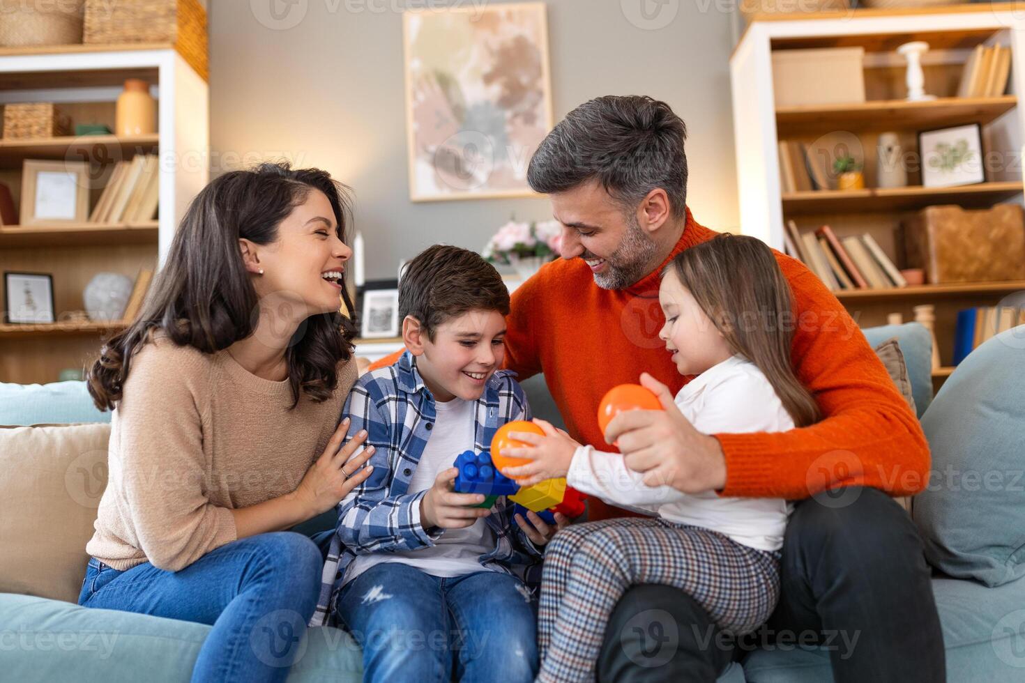 A family sitting on a couch playing with toys photo