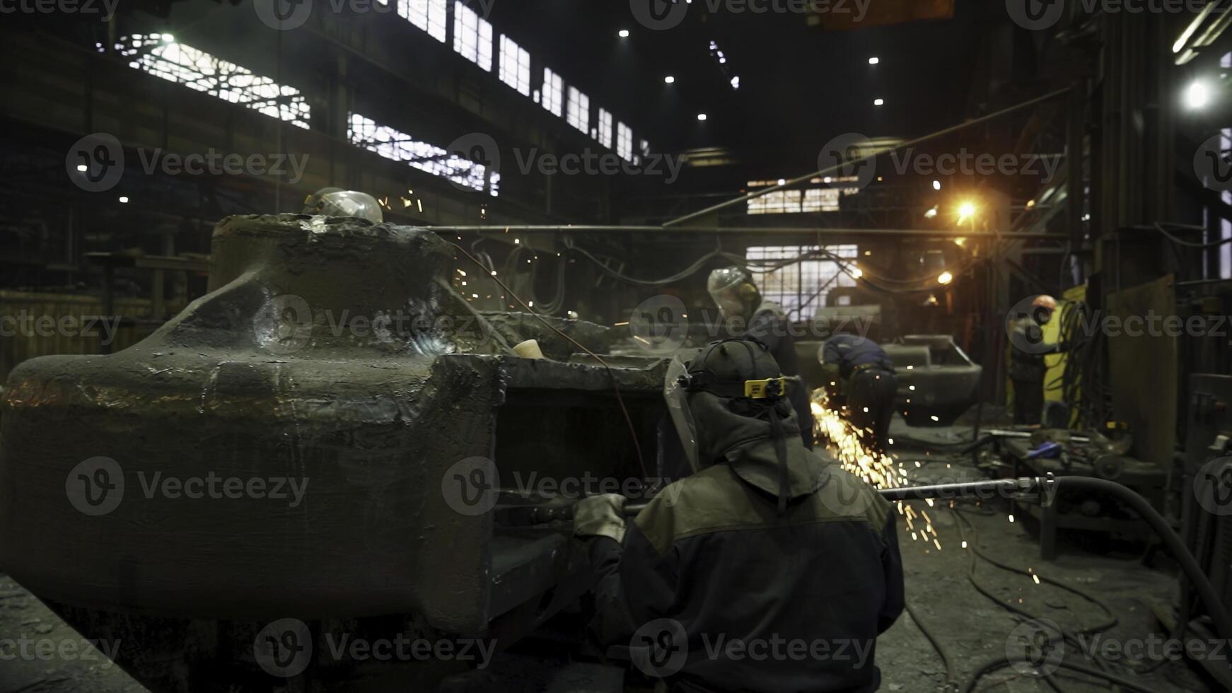 An Industrial Workshop featuring Workers engaged in various tasks within a Foundry setting. Stock Clip photo