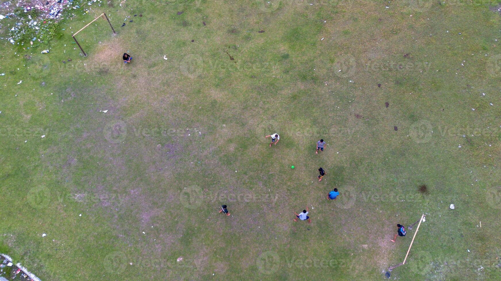Aerial view of people playing soccer on green grass field in public park photo