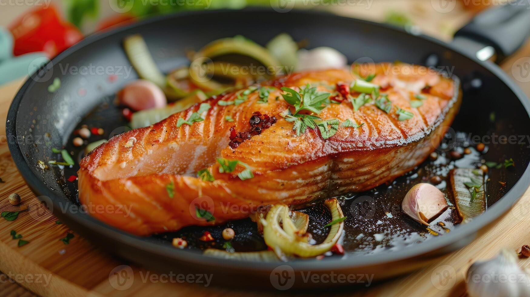 Fried salmon steak with cooked leek and garlic on frying pan on wooden table photo