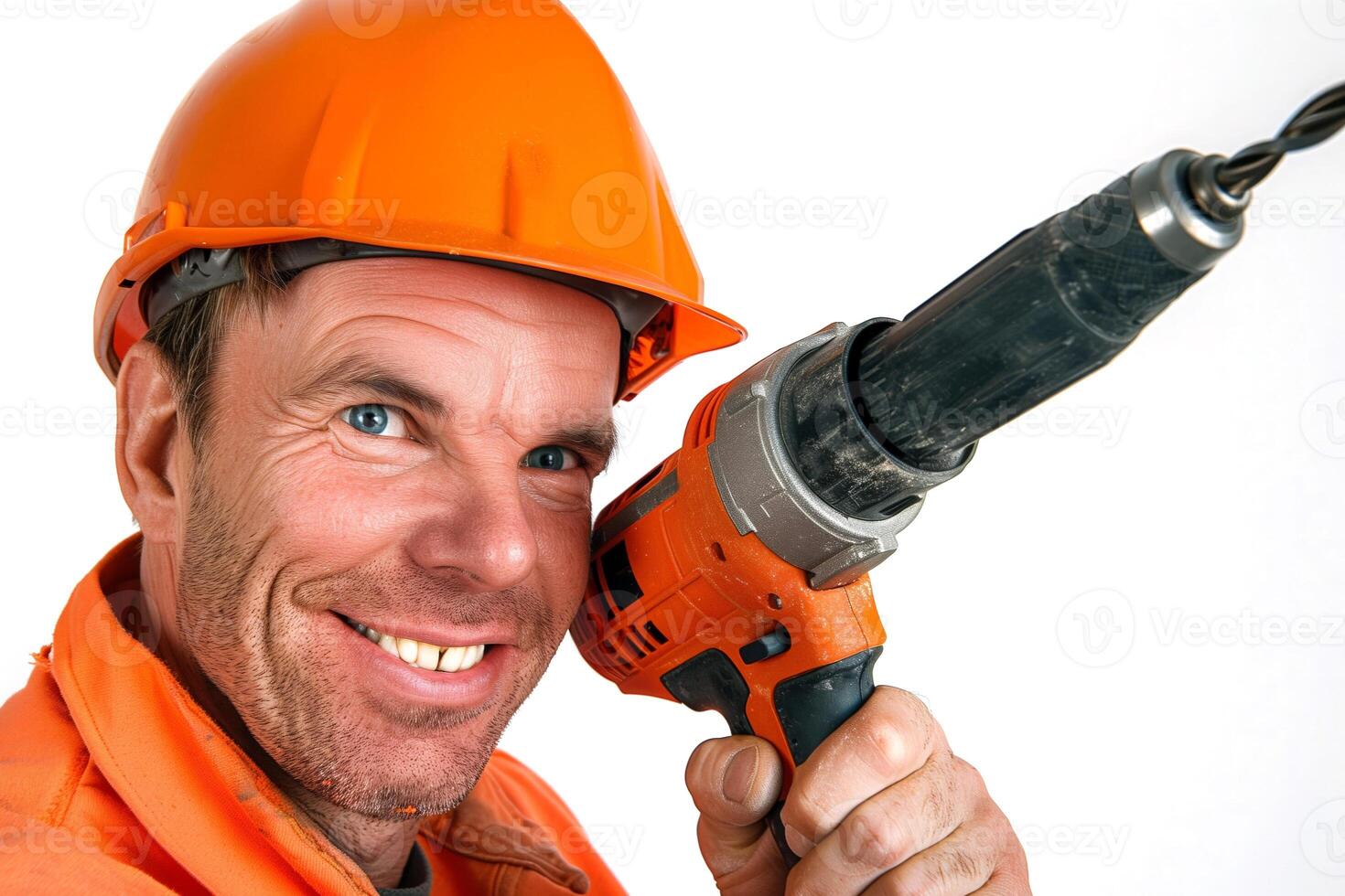 Portrait of a happy construction worker wearing a helmet with a cordless drill in hand photo