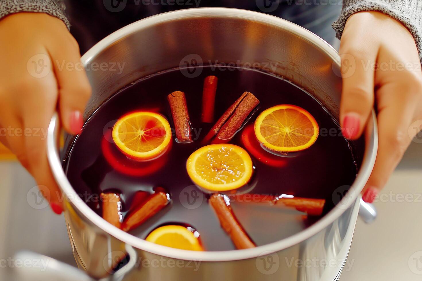 Woman making mulled wine with spices in a pot, closeup photo