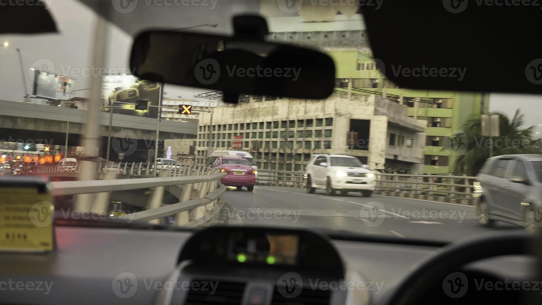 The shows a vehicle navigating busy urban traffic to highway photo