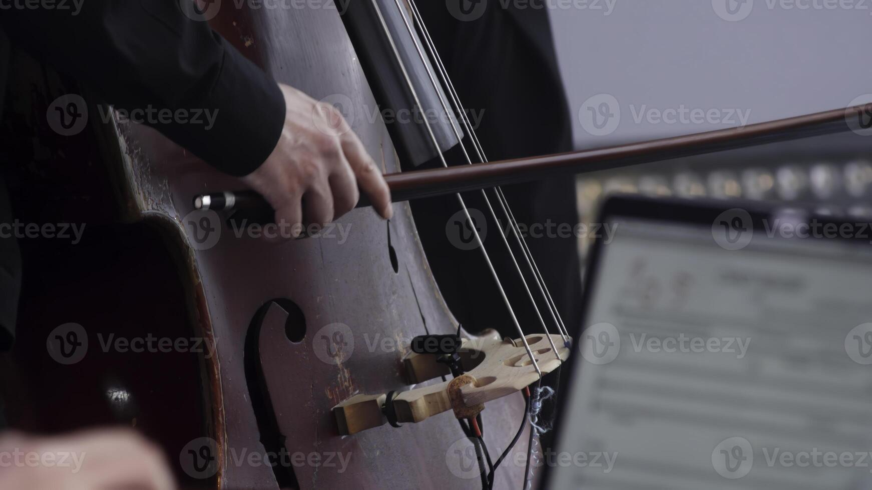A Musician is Graciously Performing with a Cello in a Contemporary Modern Setting Today. Clip photo