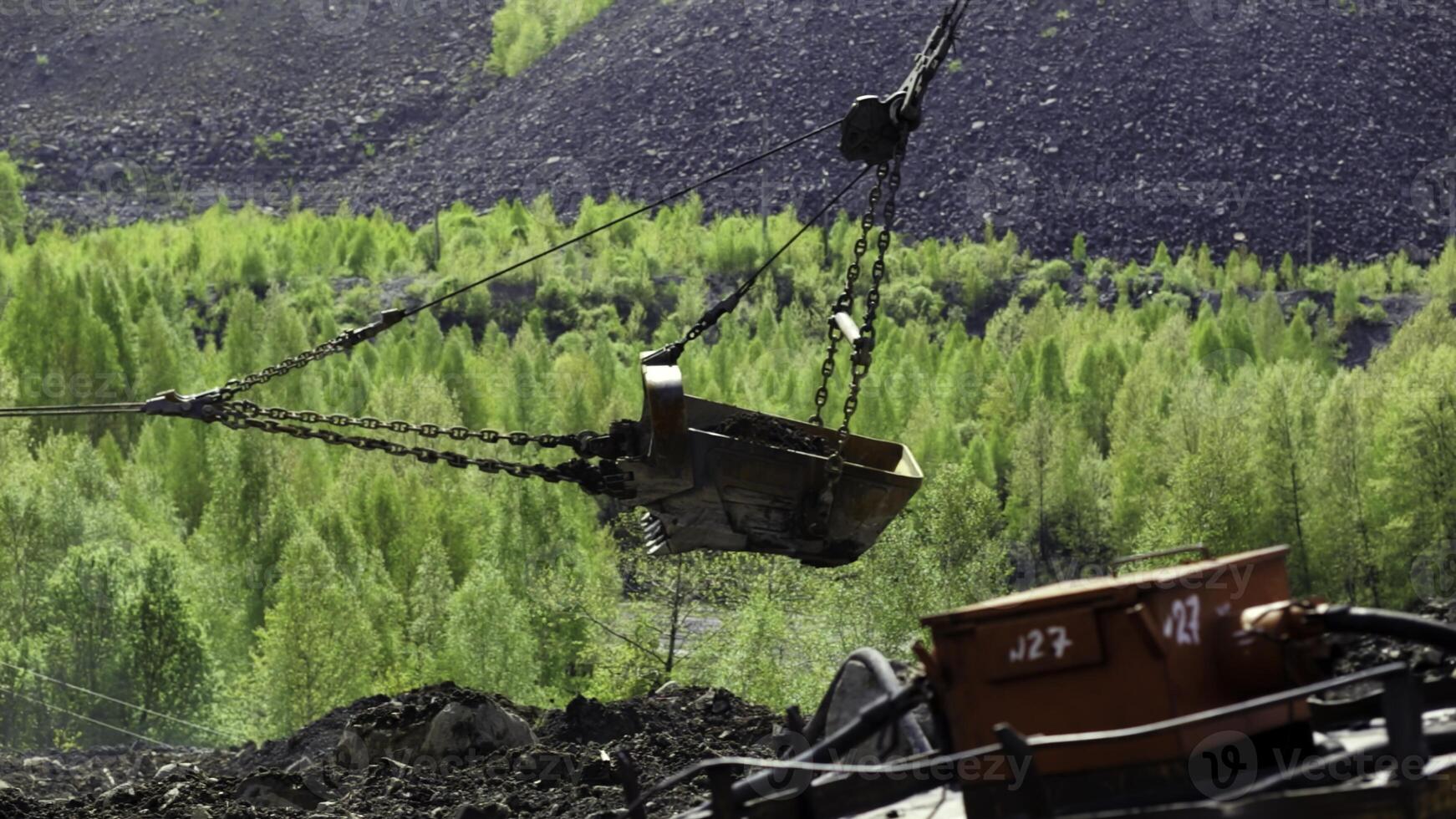 Heavy Machinery Efficiently Operating in a Lush, Green Mining Landscape Encompassing Natures Beauty. Stock Clip photo