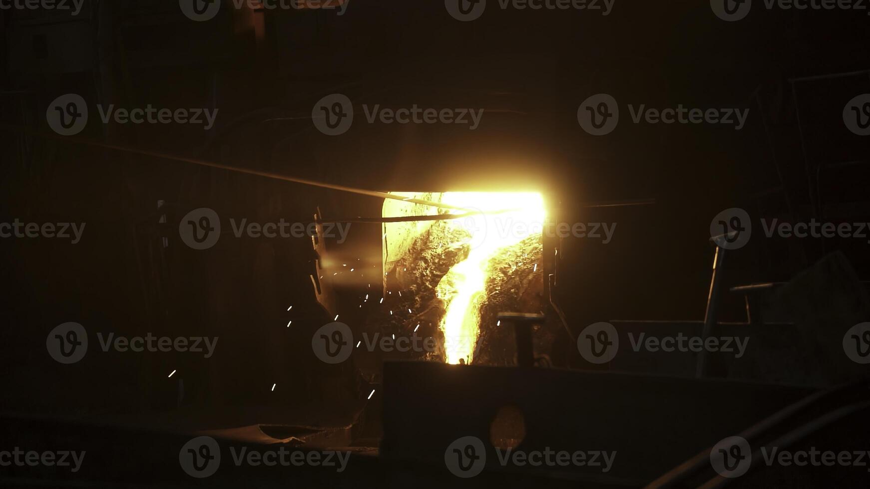 Molten metal is being poured in an industrial foundry, highlighting craftsmanship and innovation. Stock Clip photo