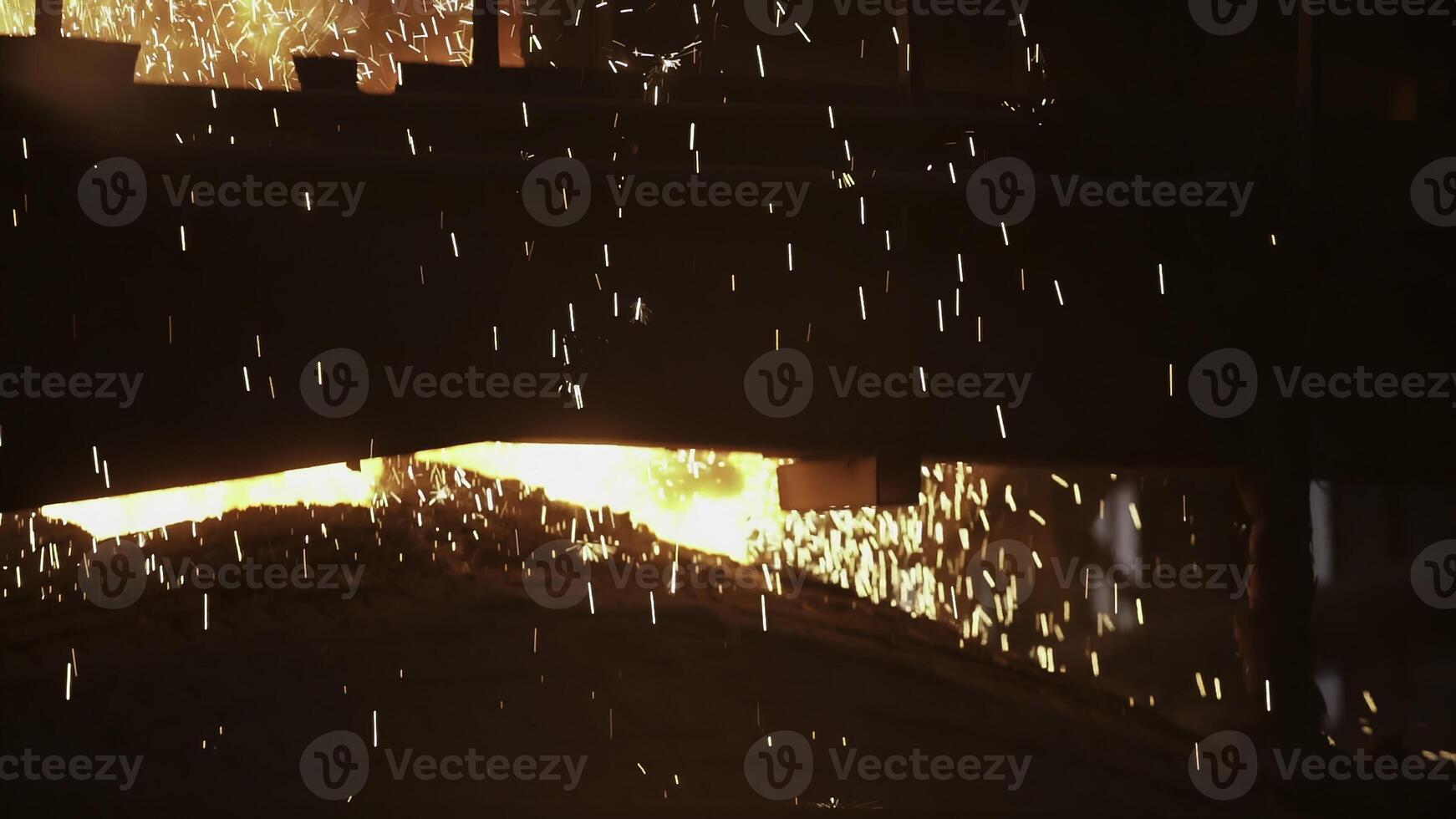 In an industrial setting, hot metal is poured with dazzling sparks, showing expertise and skill. Stock Clip photo