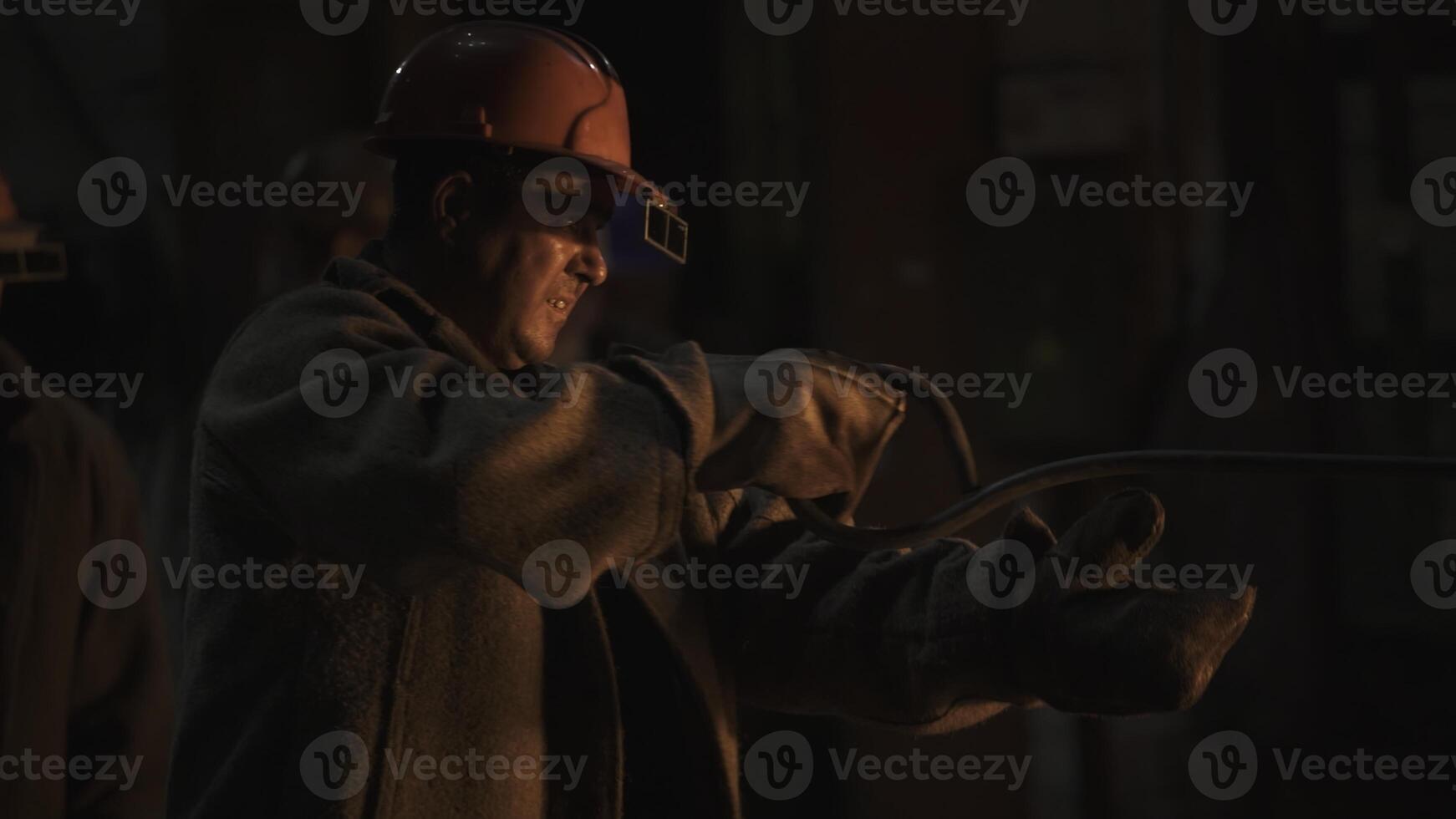 Workers in an Industrial Setting Skillfully Handling Heavy Equipment with Focus and Safety. Stock Clip photo