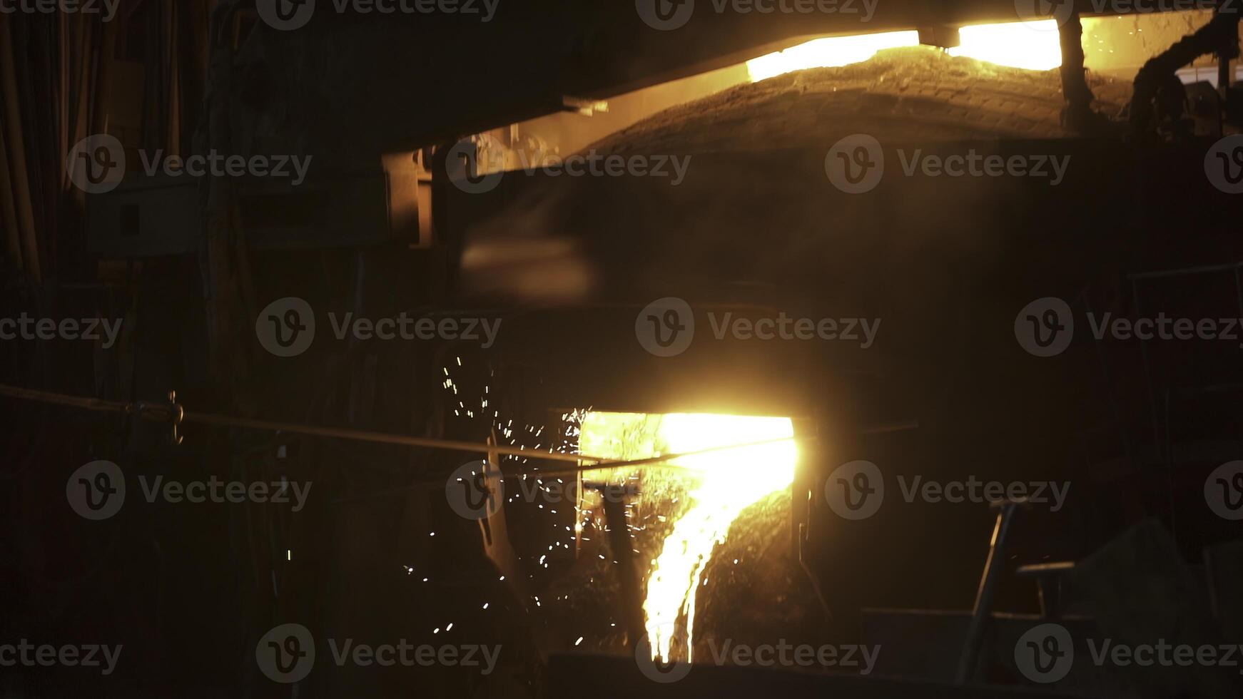 Molten Metal Pouring in a bustling Industrial Foundry, a hub of craftsmanship and heavy industry. Stock Clip photo