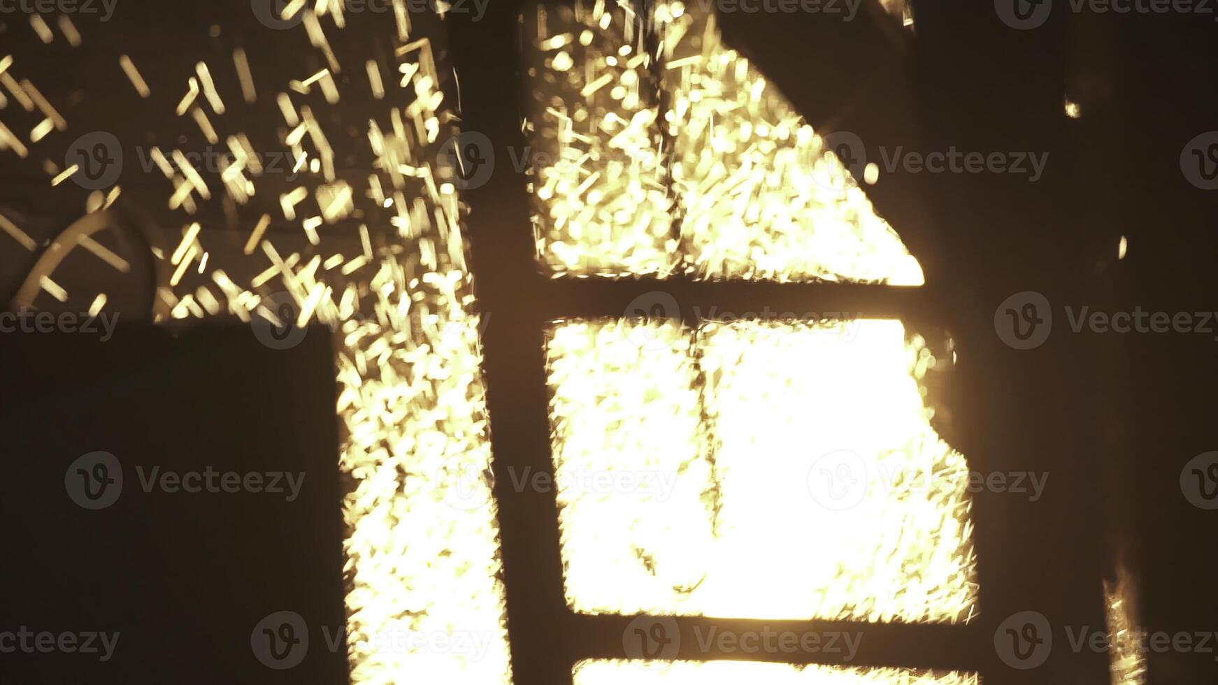 Sparks are dramatically flying from metalwork being performed in an industrial workshop environment. Stock Clip photo