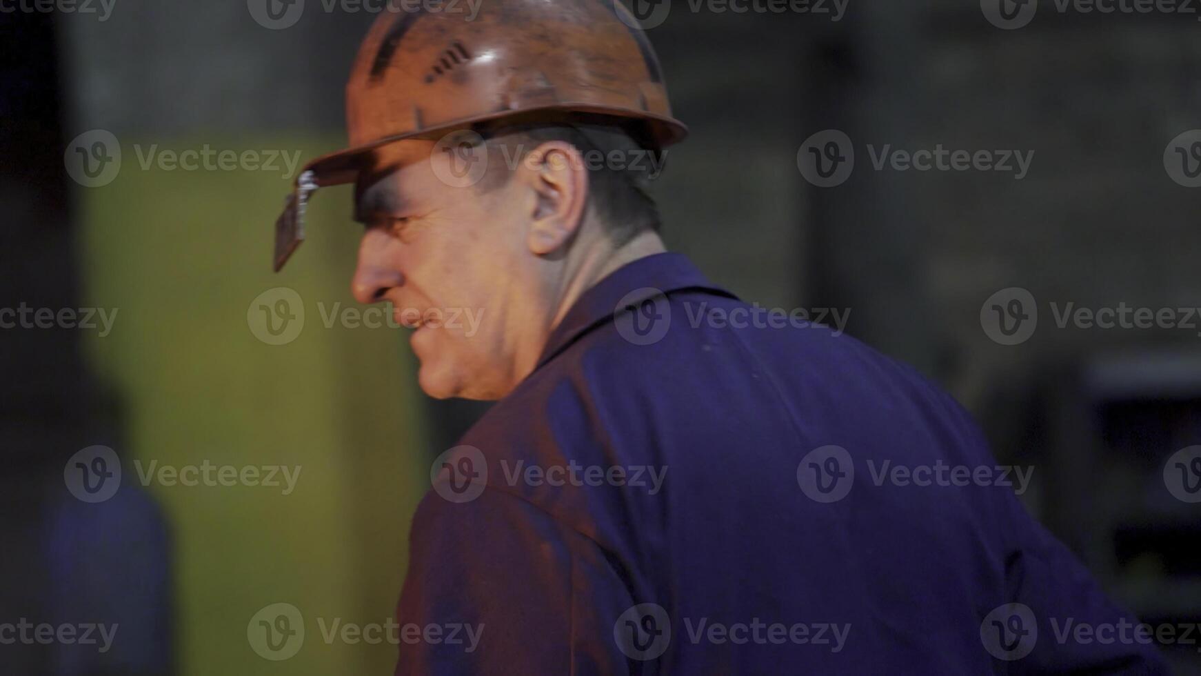 A Worker Wearing Safety Gear While Engaged in a Specific Industrial Task at a Factory. Stock Clip photo