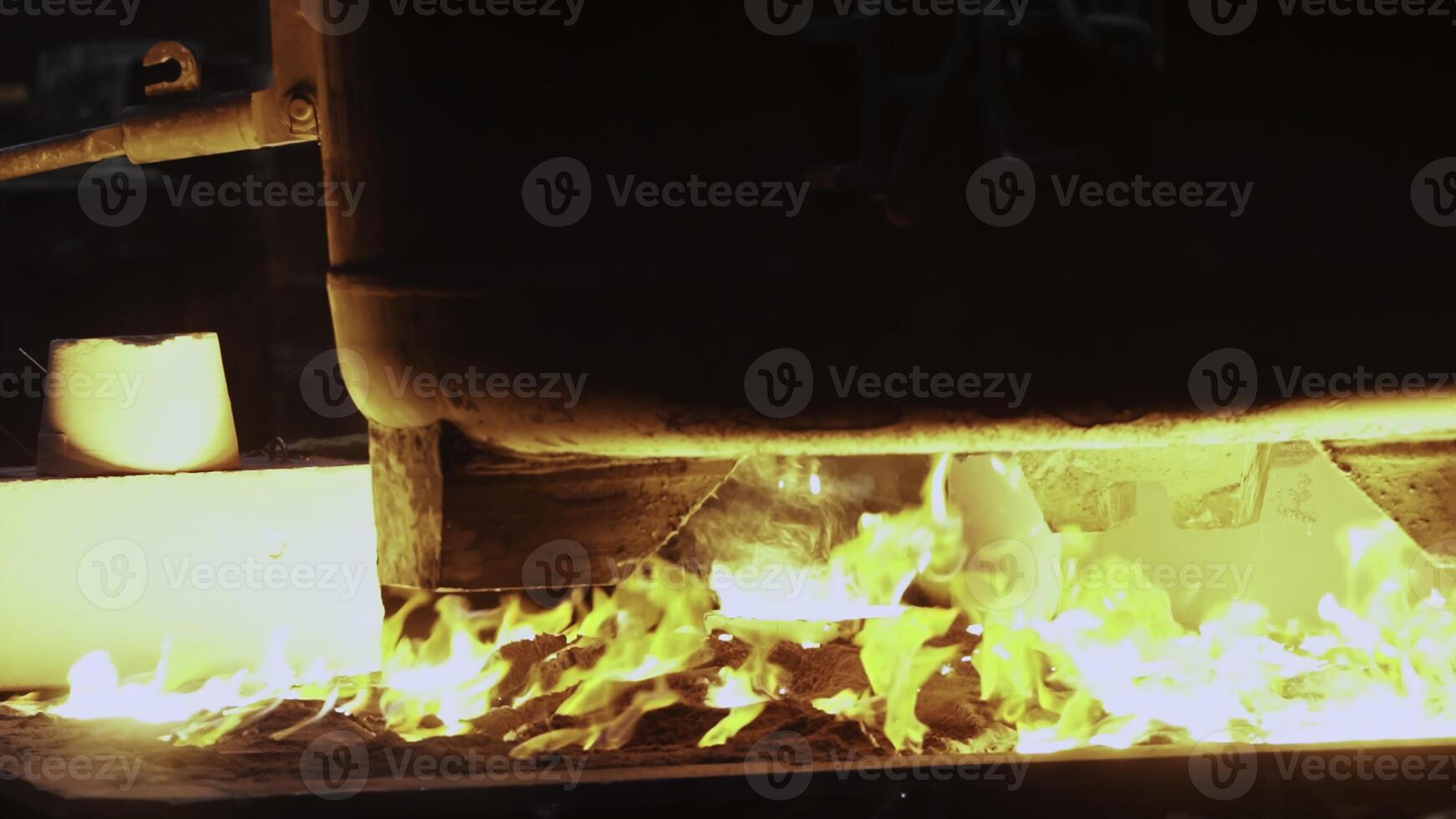 The mesmerizing sight of molten metal flowing efficiently through a foundry workshop. Stock Clip photo