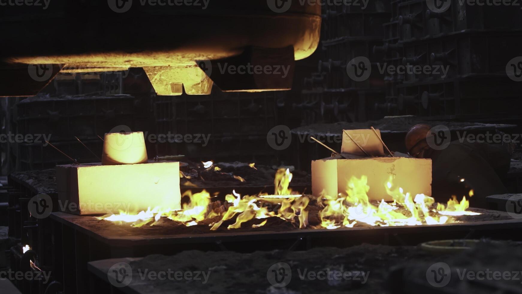 The intriguing process of pouring molten metal in a foundry environment is fascinating. Stock Clip photo