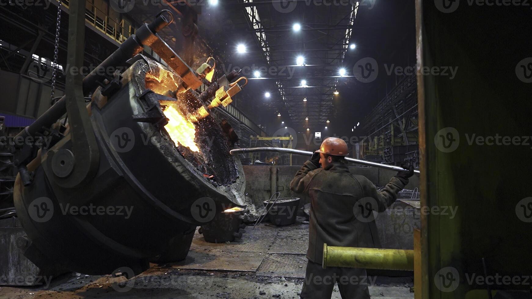 Industrial Foundry Operation involves safely working with Molten Metal for various applications. Stock Clip photo
